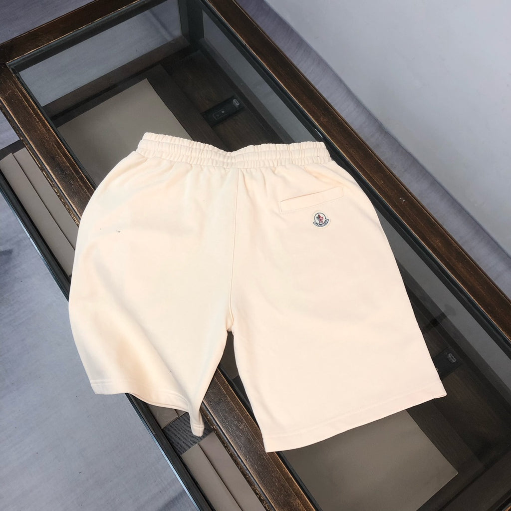 Stone Island cream shorts with elastic waistband and small circular logo on front