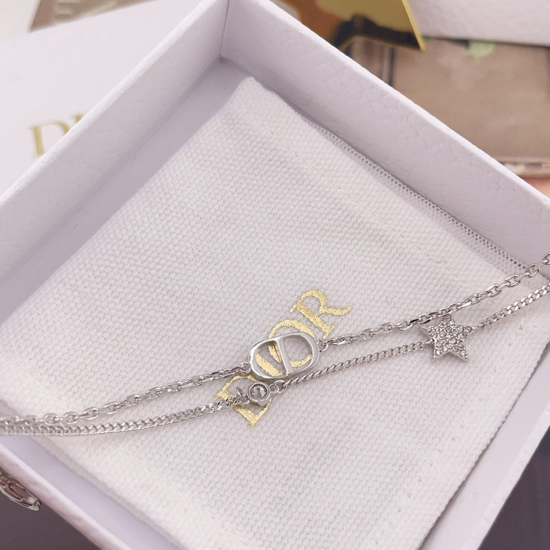 Silver-tone necklace in white box with CD logo link and star charm