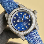 Rolex Submariner watch with blue dial, blue textured strap, jeweled bezel