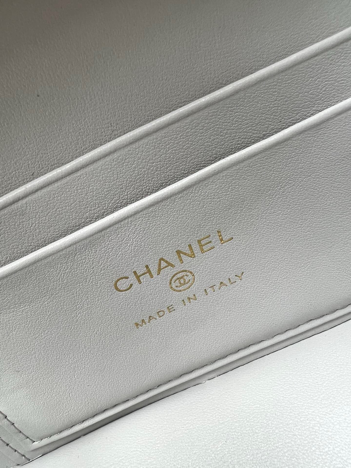 Chanel interior label: CHANEL and MADE IN ITALY on light gray leather