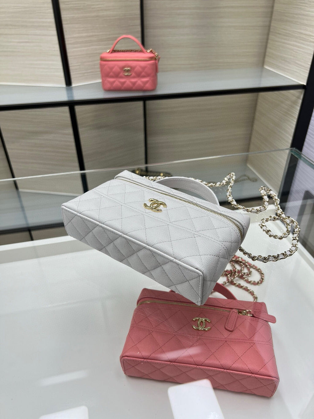 Chanel quilted shoulder bag with chain strap in light gray and a pink mini top-handle