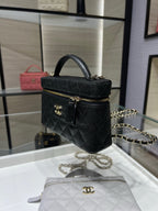 Chanel black quilted mini tote bag with gold hardware, top handle, and chain strap