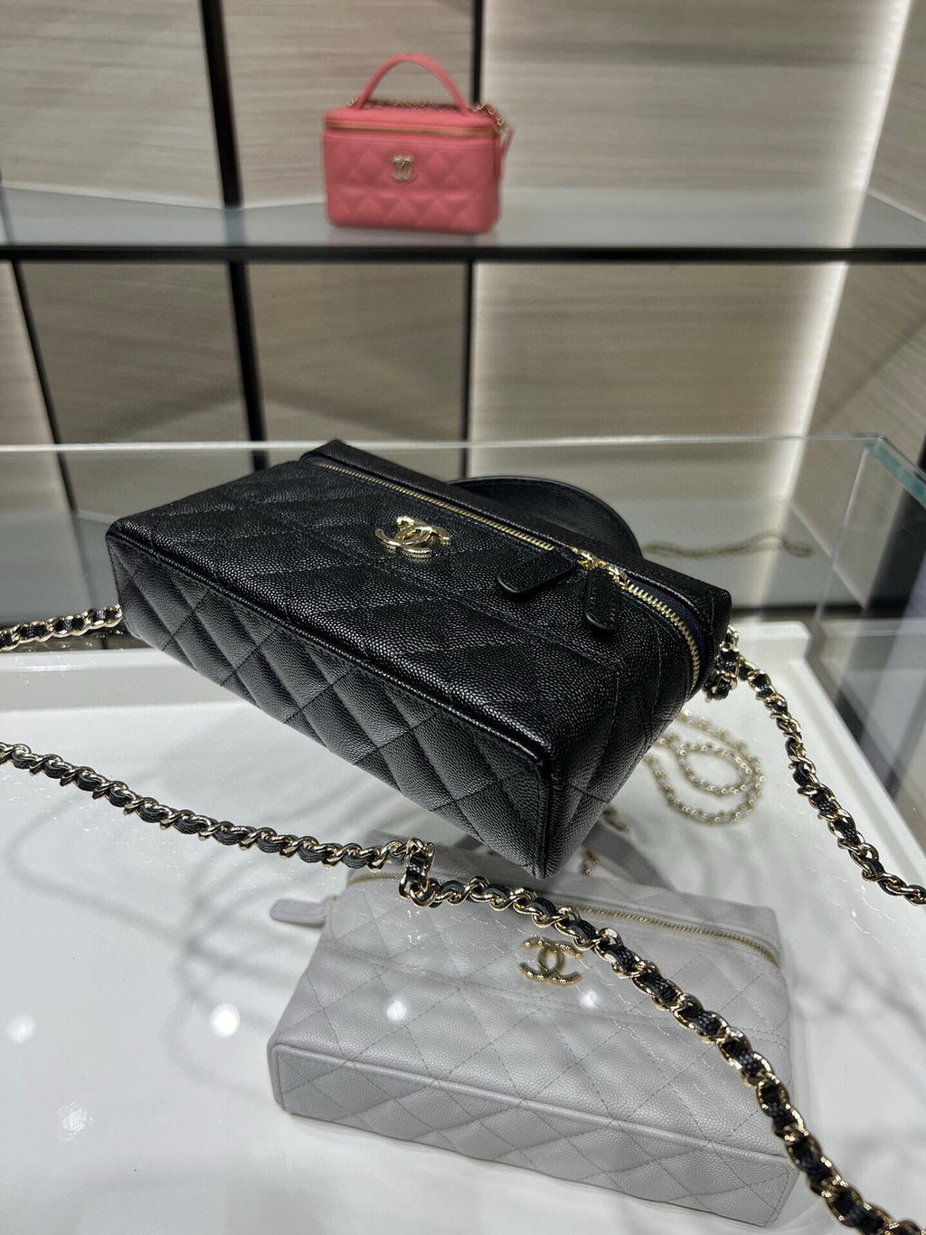 Chanel quilted black top-handle bag with gold zipper and chain shoulder strap