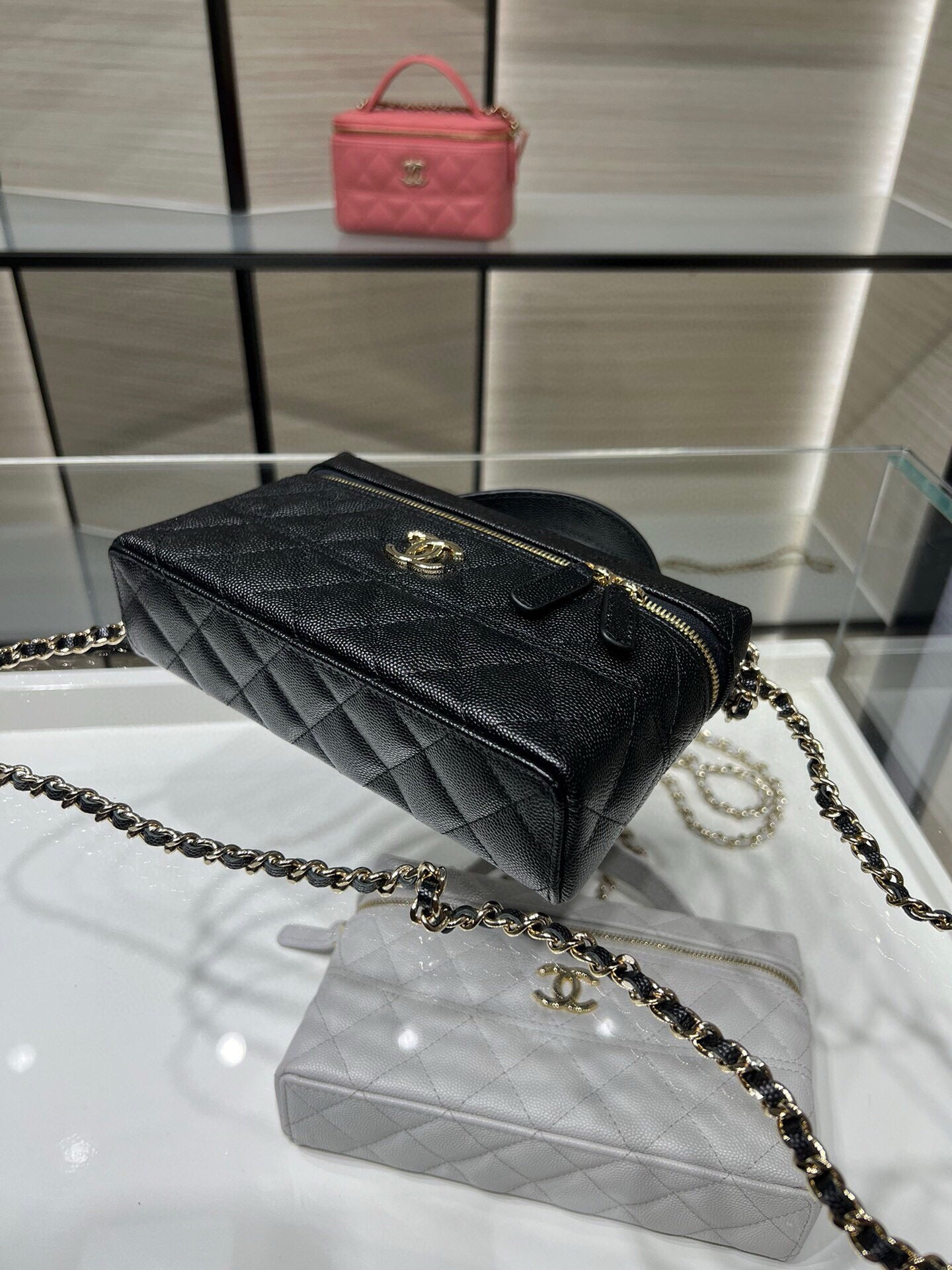 Chanel quilted black top-handle bag with gold zipper and chain shoulder strap