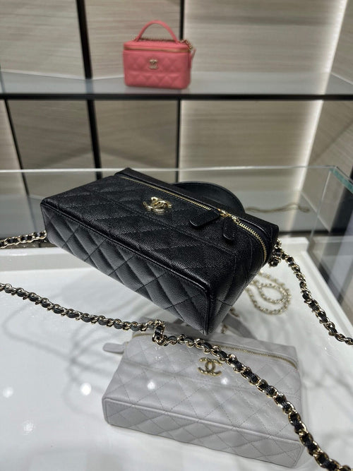 Chanel quilted black top-handle bag with gold zipper and chain shoulder strap