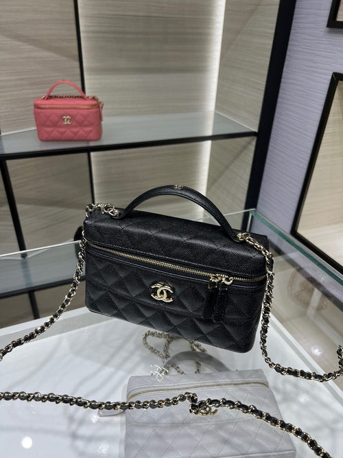 Chanel quilted black mini bag with top handle, chain strap, and gold CC clasp