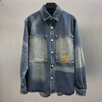Blue denim button-up jacket with pointed collar, chest pockets, and logo patch