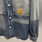 Denim jacket front with logo patch, snap buttons, and flap chest pocket