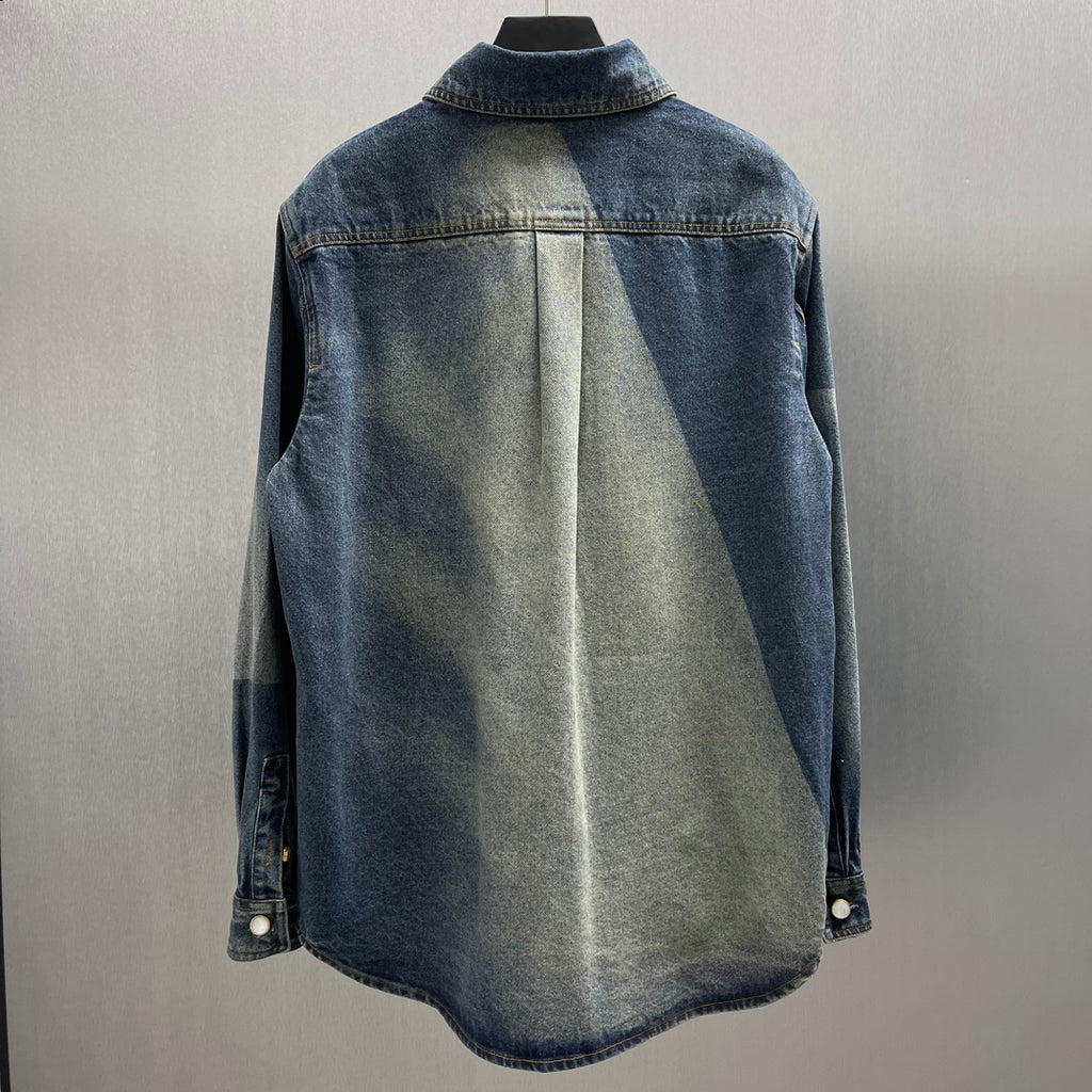 Back view of blue denim jacket with central seam and buttoned cuffs