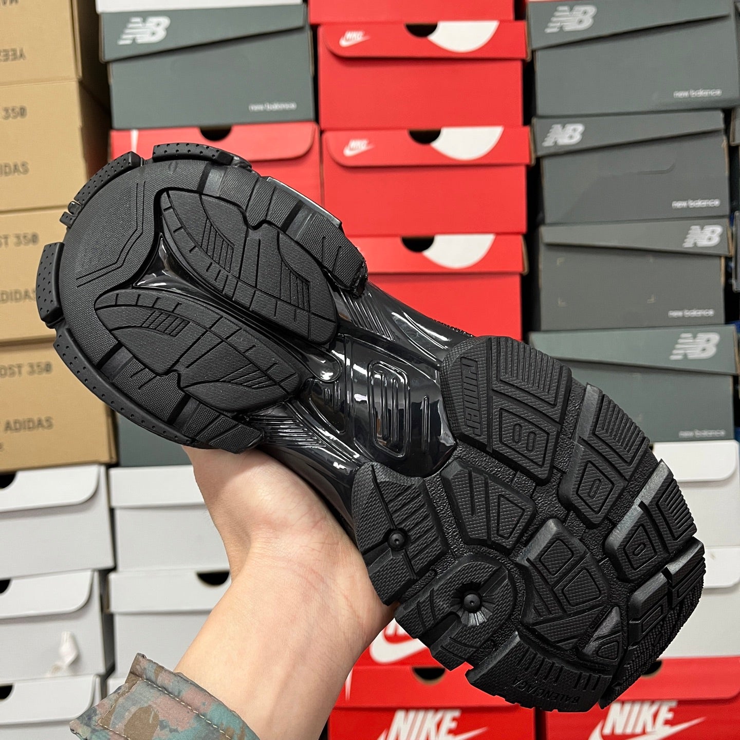 Black Balenciaga running shoe outsole with traction tread and herringbone pattern