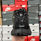Black Balenciaga running shoe with heel tab showing BALENCIAGA and size 41