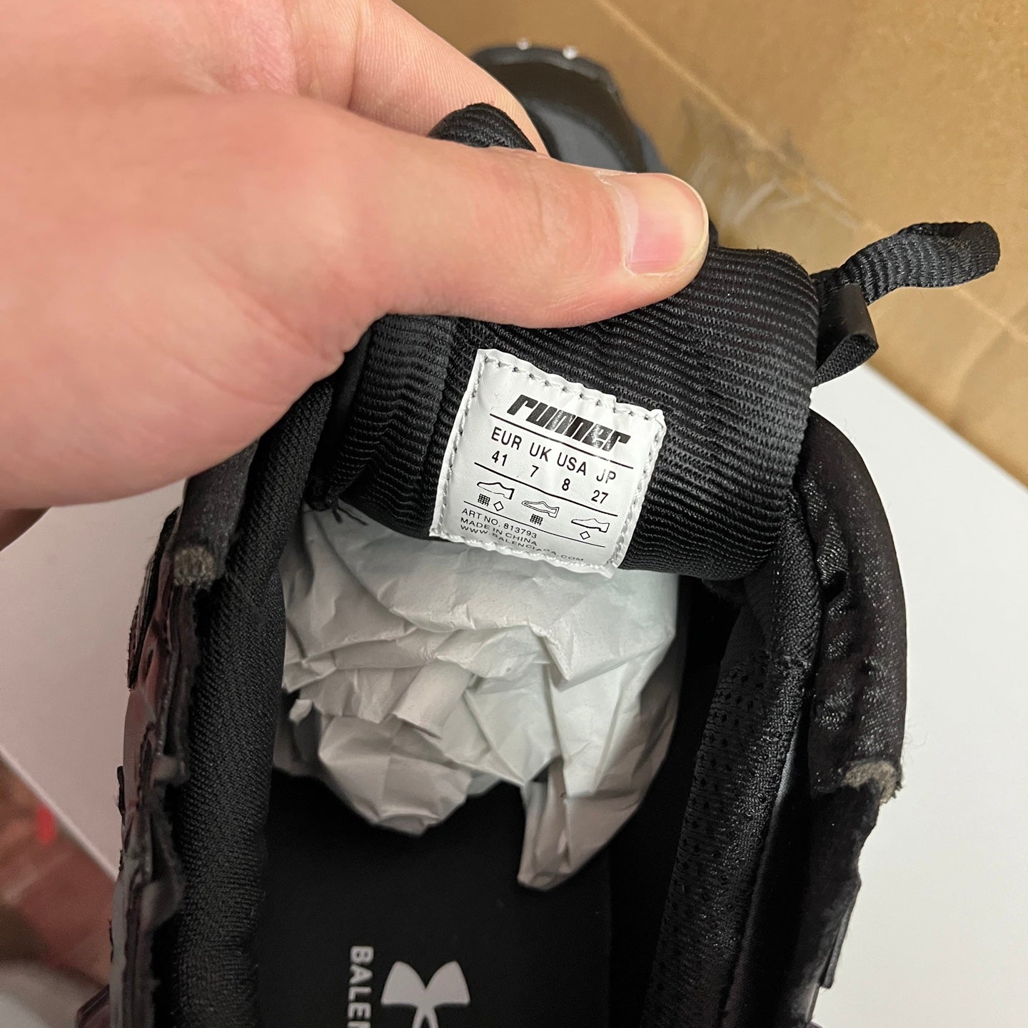 Black shoe inner size tag showing 41 and Balenciaga, made in China