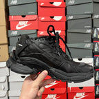 Black Balenciaga running shoe, side angle with lace-up closure and logo detail