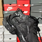 Black Balenciaga running shoe with side branding and padded collar
