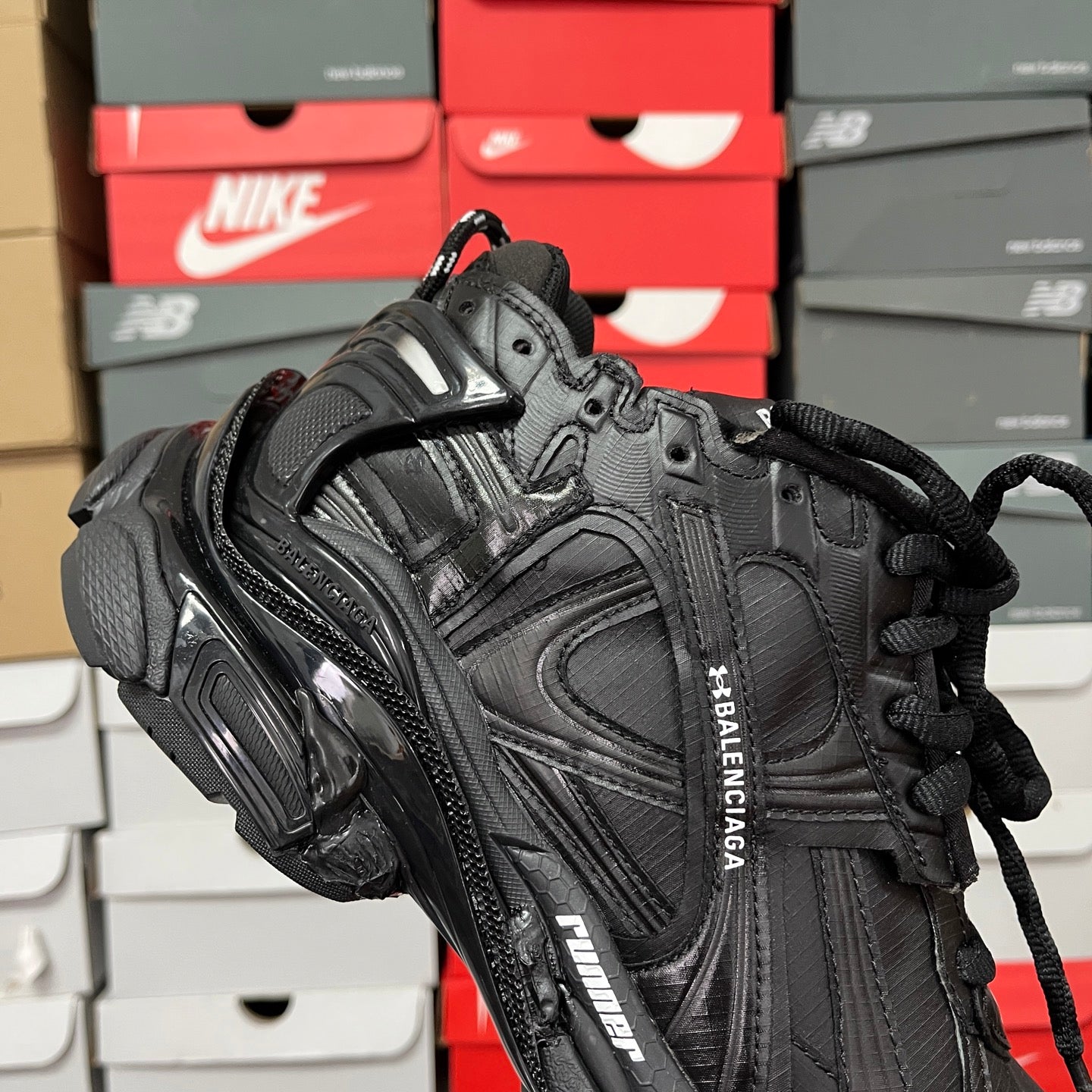 Black Balenciaga running shoe with side branding and padded collar