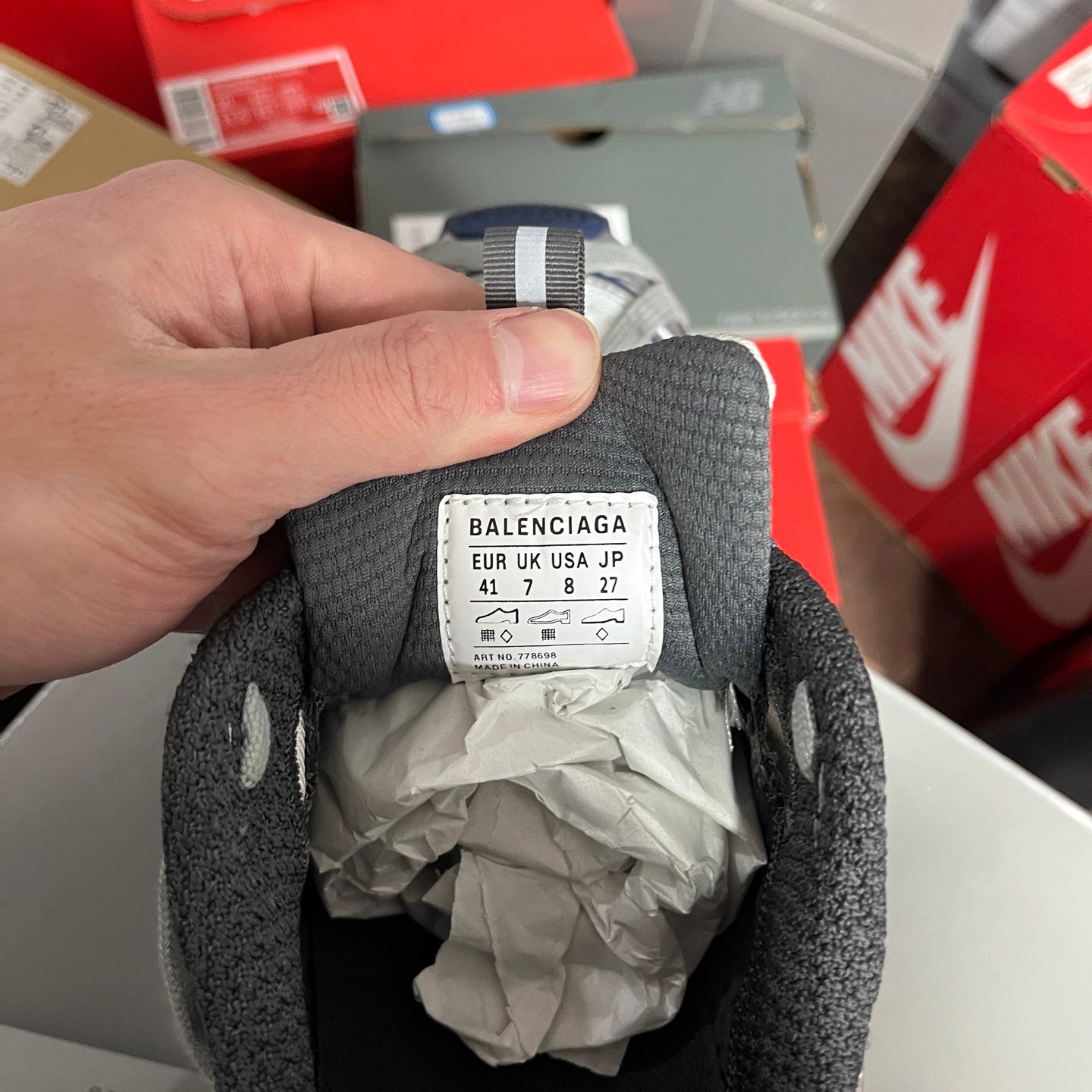 Inside label in the collar of grey athletic shoes with size and brand info.
