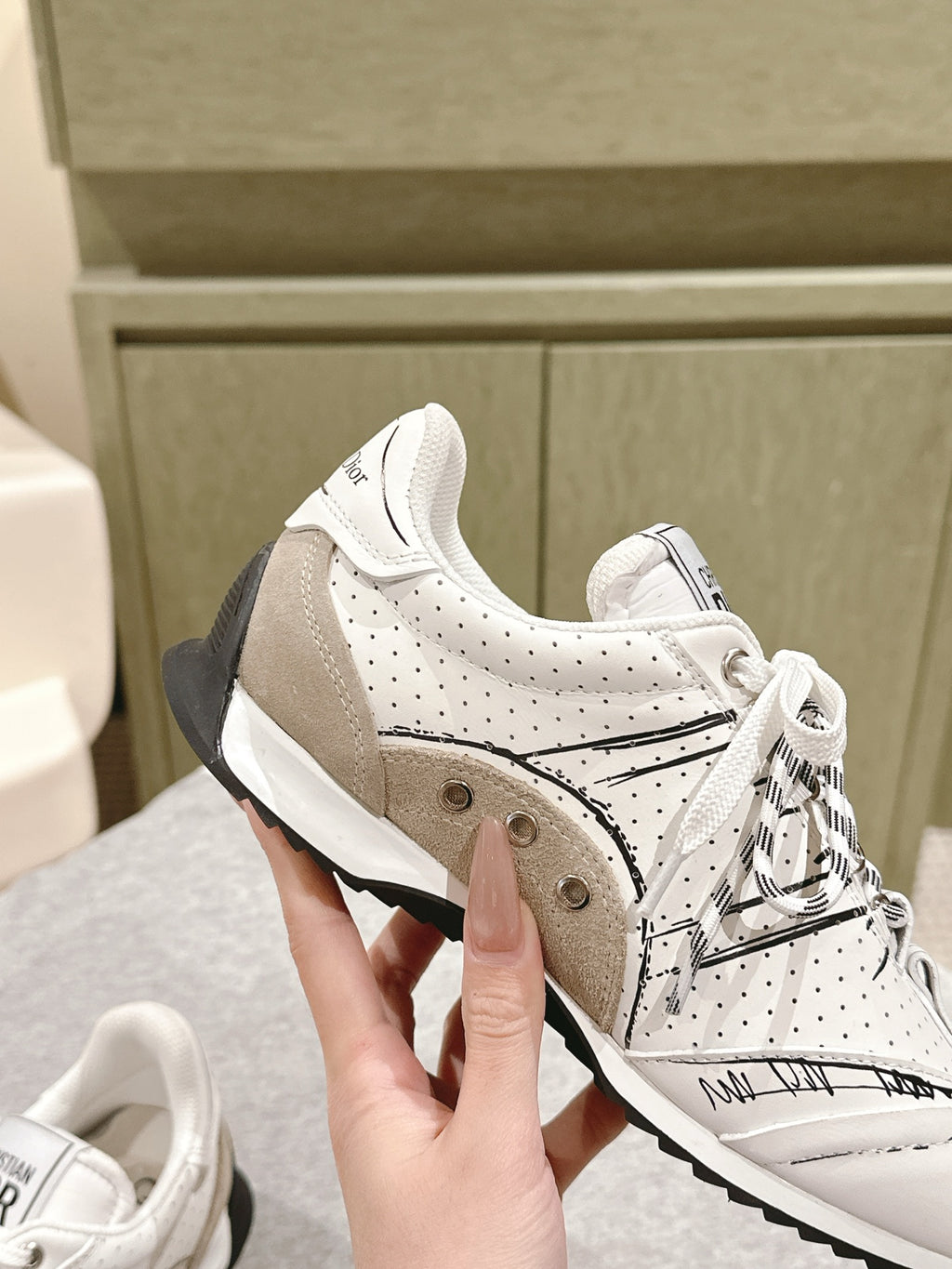 Dior unisex sneakers close-up, white with beige panels and black heel detail