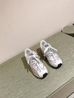 Dior unisex sneakers, white with beige inserts and black soles, side-by-side