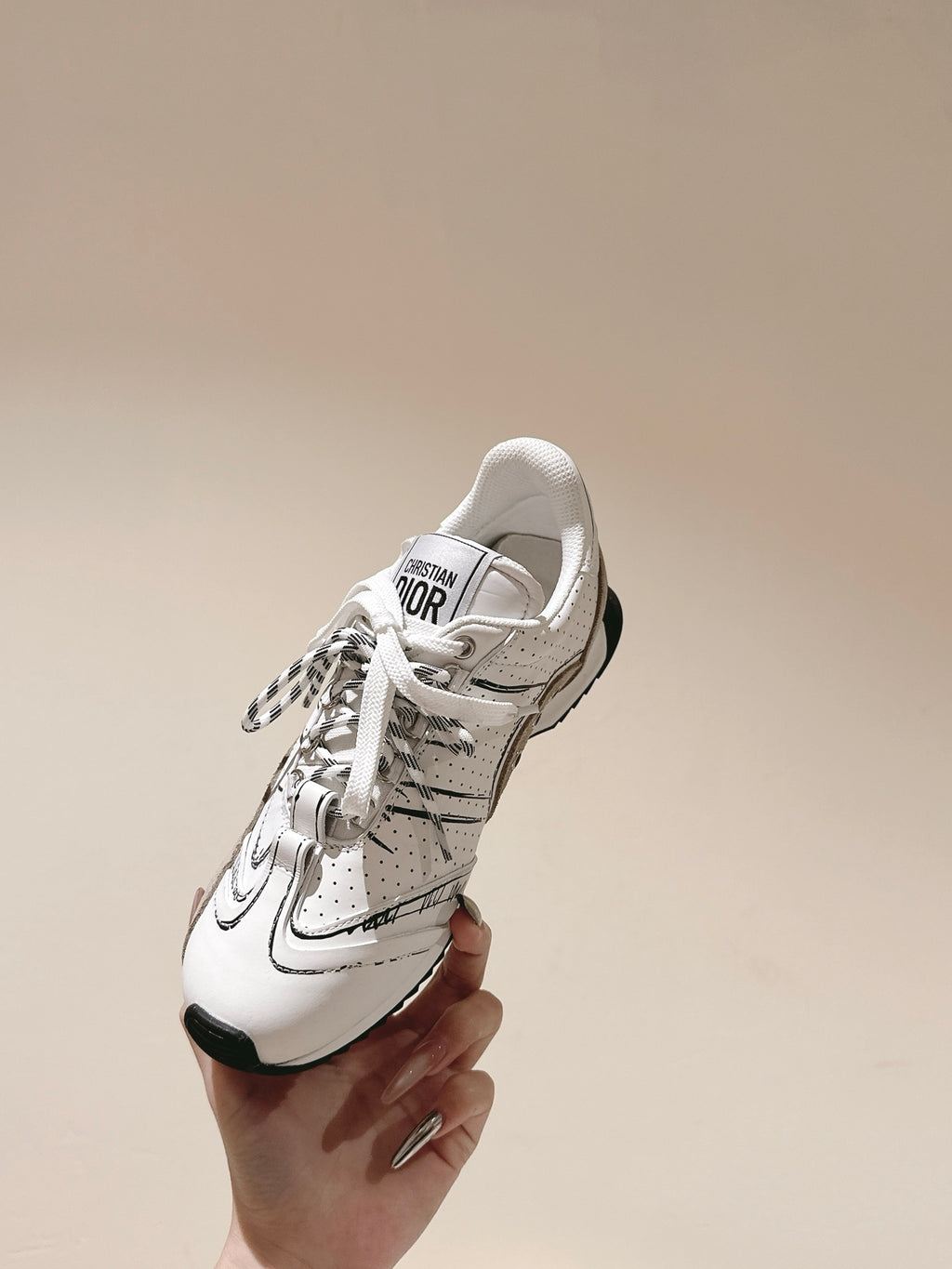 Dior unisex sneaker, white leather with black sole and Dior logo on tongue