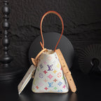 Louis Vuitton monogram bucket bag with tan strap and colorful logo print, orange cord trim