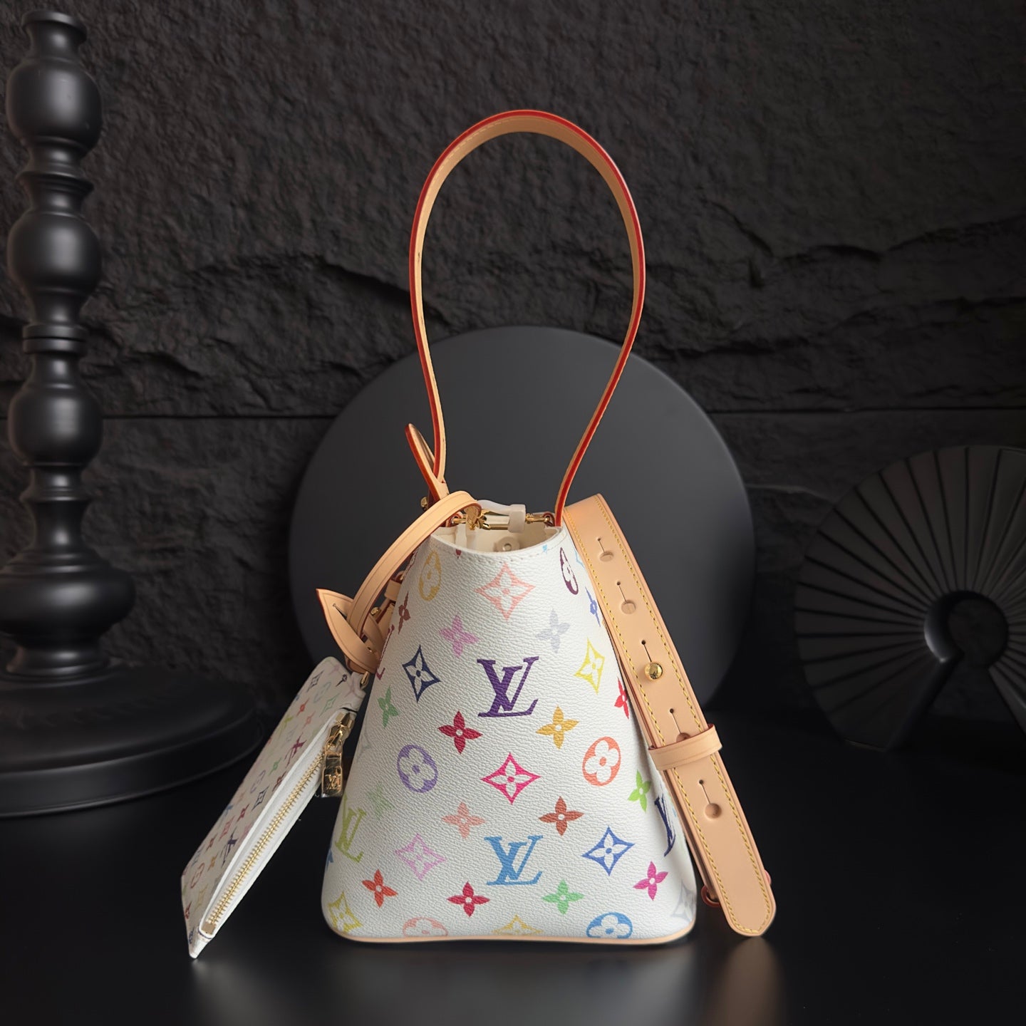 Louis Vuitton monogram bucket bag with tan strap and colorful logo print, orange cord trim