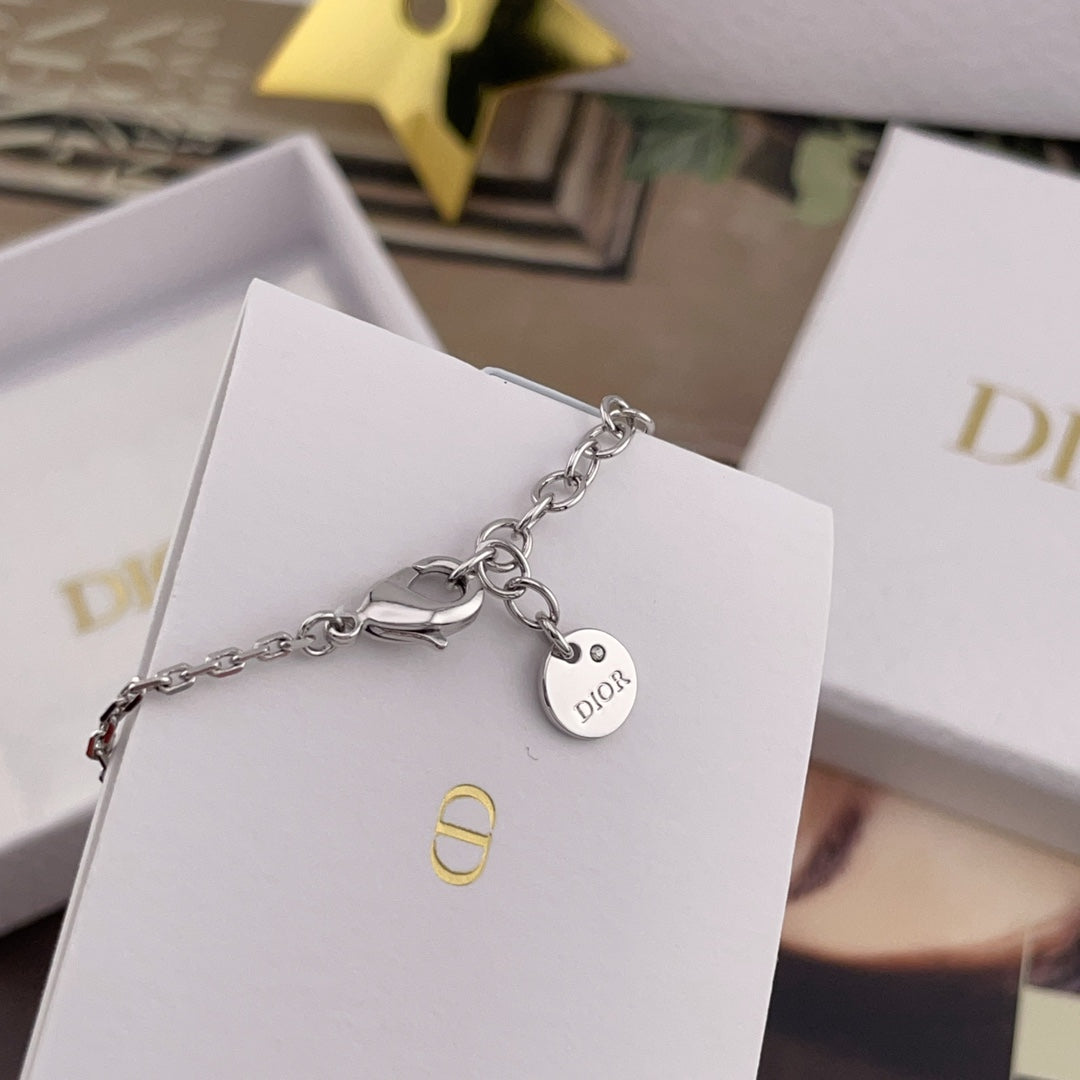 Dior necklace with charm tag and small logo pendant on a white card