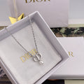 Dior necklace with silver chain and pendant charm in a white gift box