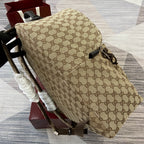 Gucci men's mini backpack in beige GG pattern, side view with black hardware and trim