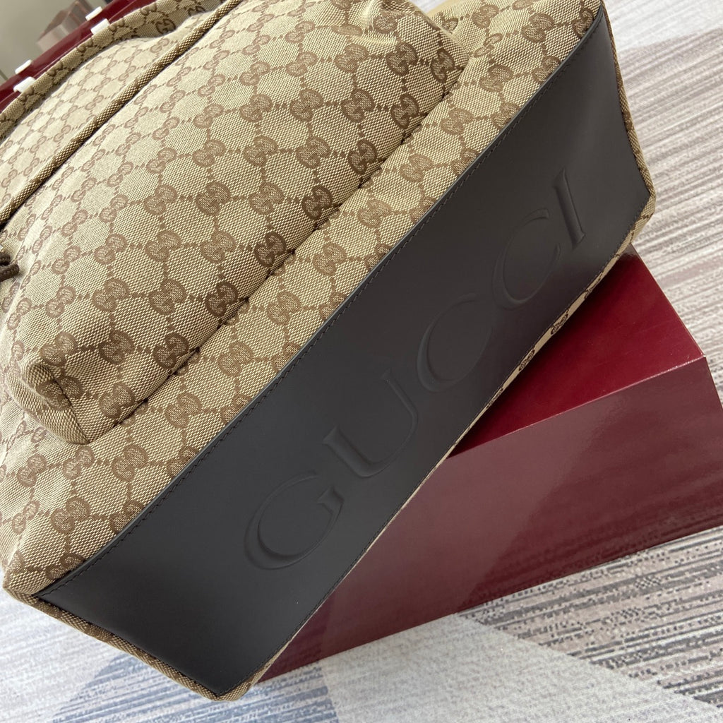 Gucci men's mini backpack with black side panel and embossed logo on the trim
