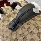 Gucci men's mini backpack close-up of beige GG pattern and black top handle