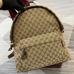 Gucci men's mini backpack in beige GG pattern, front view with zipper pull and leather trim
