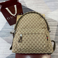 Gucci mini backpack in GG canvas with leather trim, zip top and strap accents
