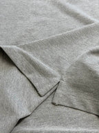 Light gray polo shirt fabric and seam detail with short sleeve edge