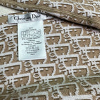 Beige knit fabric care label reading Christian Dior and product details