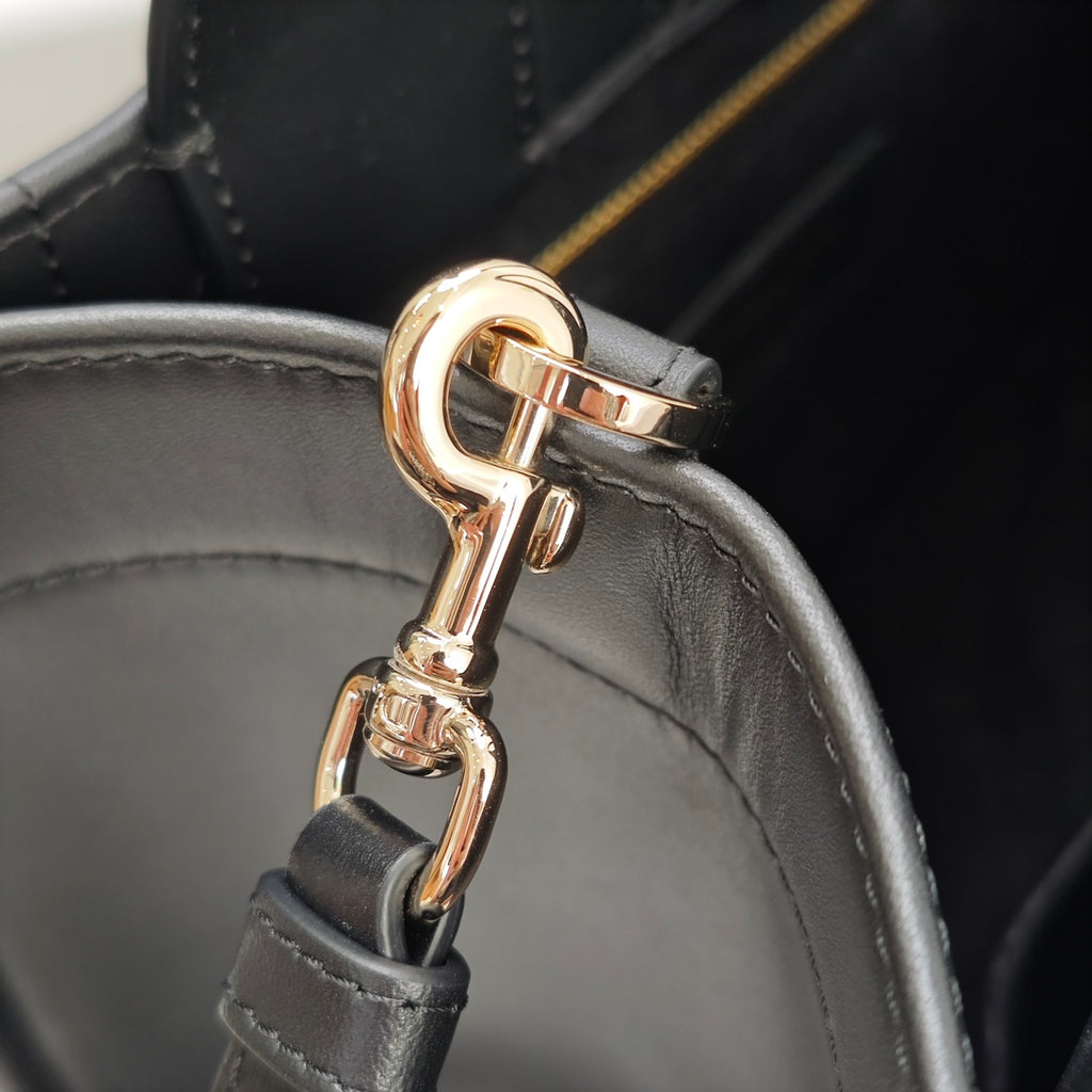 Black strap connector with gold-tone clasp hardware