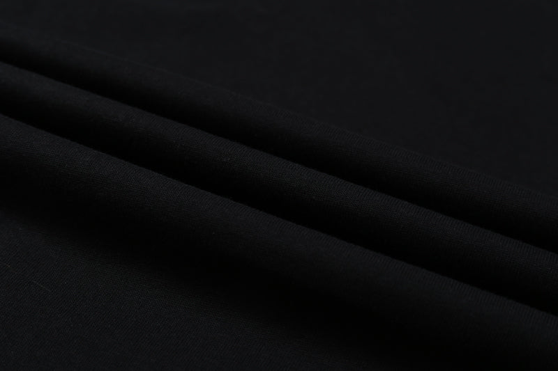 Black T-shirt fabric close-up showing smooth knit texture