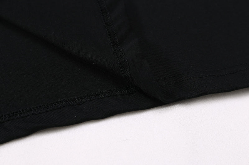 Black T-shirt hem seam with visible stitching close-up