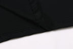 Black T-shirt hem seam with visible stitching close-up