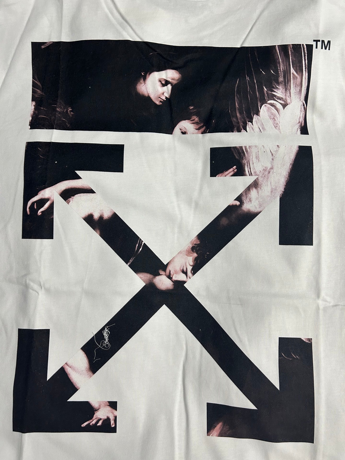 Off-white T-shirt with large black-and-white graphic and bold arrow X on front