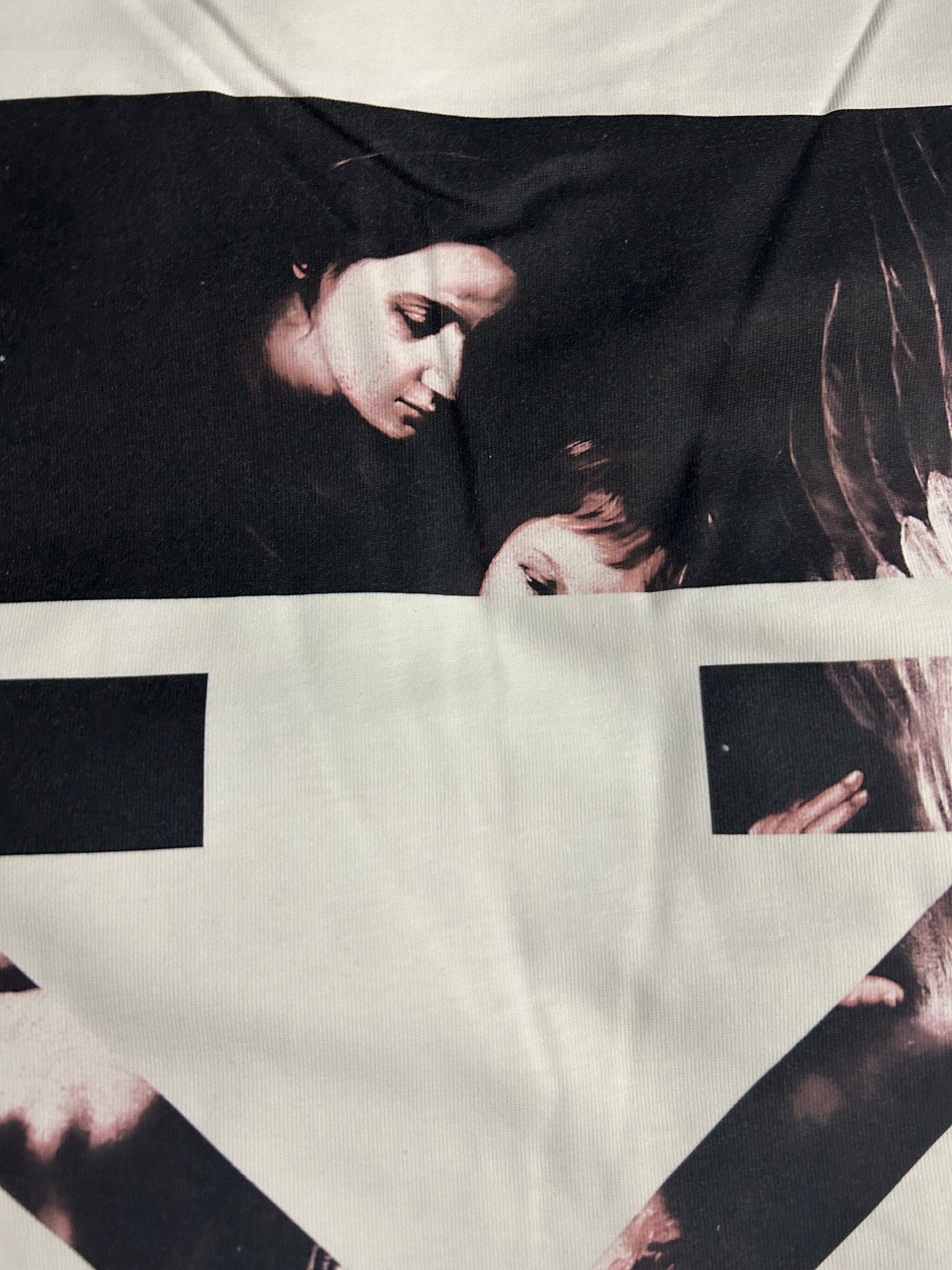 Off-white T-shirt with close view of black-and-white graphic across front