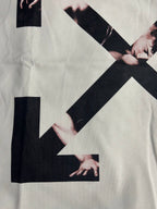 Off-white T-shirt close-up with arrow X graphic and black block accents