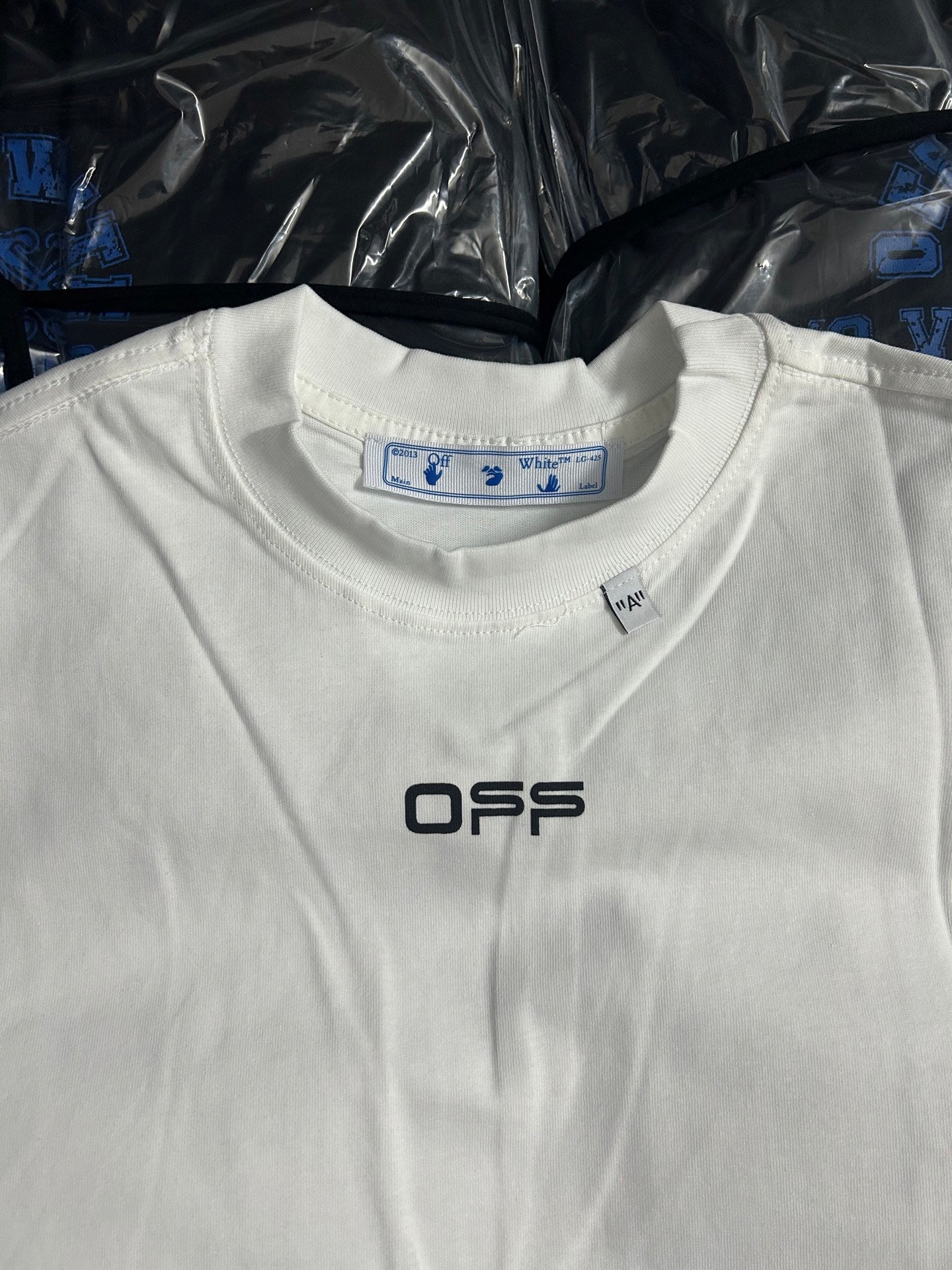Off-white T-shirt with blue neckline tag and OFFS logo