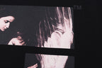 Black T-shirt close-up of large X photo graphic print