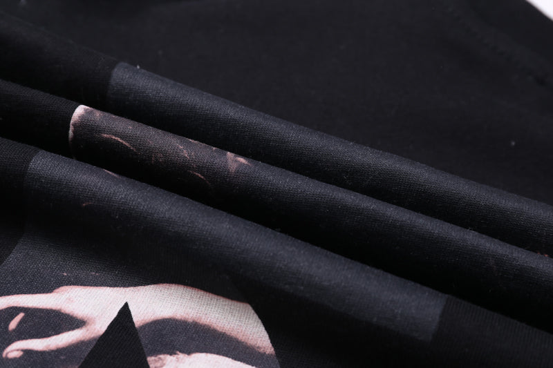 Black T-shirt fabric close-up with partial photo graphic print