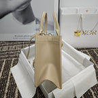 Beige leather handbag with zip top, two handles, and side view