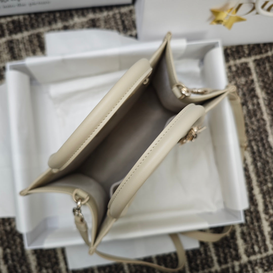 Beige handbag interior view with two compartments and zipper trim