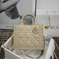 Beige quilted handbag with top handles and front logo clasp