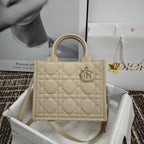 Beige quilted handbag with top handles and front logo clasp