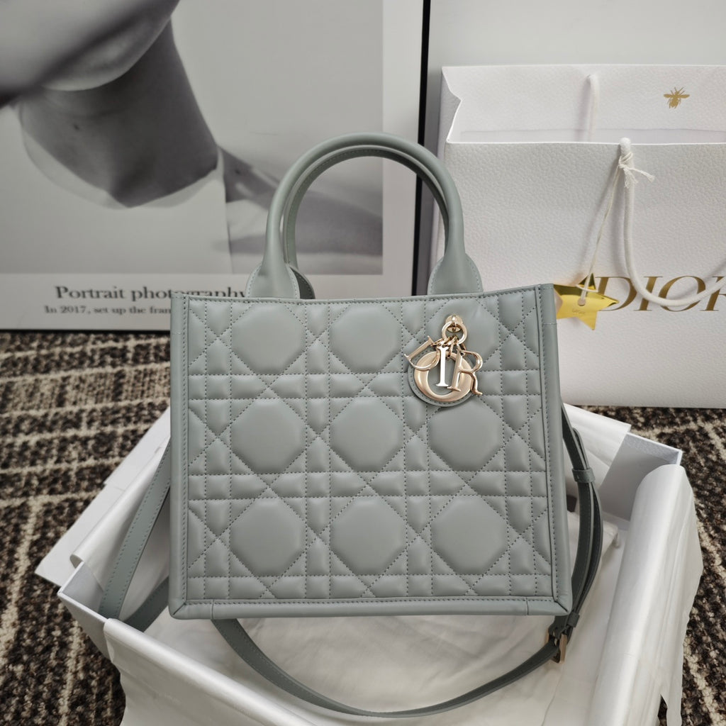 Dior quilted tote bag with top handles and gold-tone emblem clasp, light blue