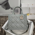 Dior quilted tote bag with top handles and gold-tone emblem clasp, light blue